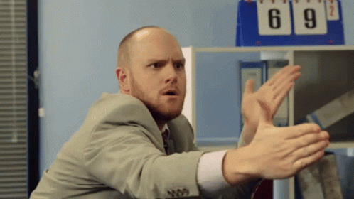 Man In Suit Making Funny Face By Scoreboard GIF