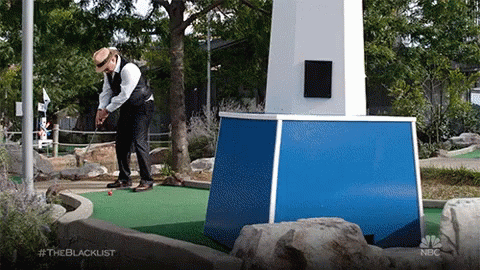 A Man In A Suit Is Playing A Game Of Golf On A Nbc Show Called The Blacklist GIF
