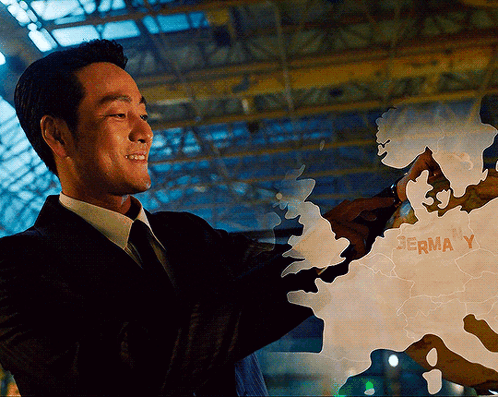 A Man In A Suit Is Pointing At A Map That Says Germa Y On It GIF