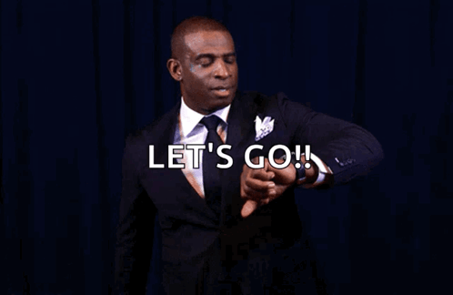 A Man In A Suit Is Pointing At His Watch With The Words Let 'S Go You Know What Time It Is GIF