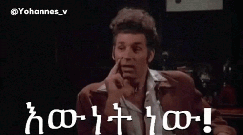 A Man In A Suit Is Pointing At Something In A Dark Room With The Words Yohannes_v Written On The Bottom GIF