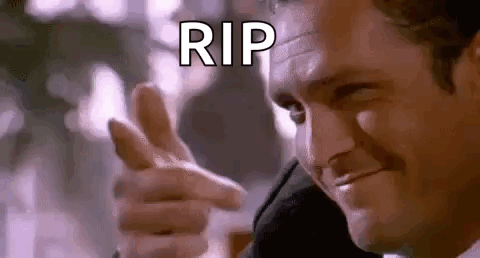 A Man In A Suit Is Pointing His Finger At The Camera And Saying `` Rip '' . GIF