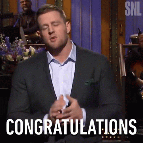 A Man In A Suit Is Saying Congratulations In Front Of A Band GIF