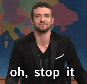 A Man In A Suit Is Saying " Oh , Stop It " GIF