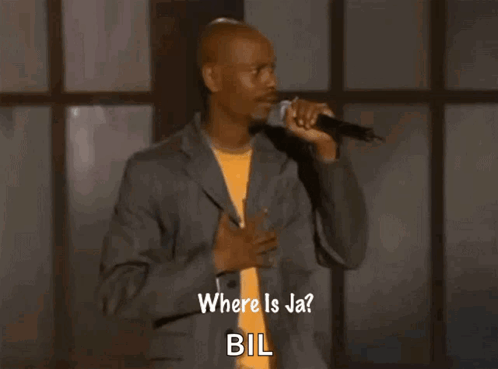 a man in a suit is singing into a microphone and says where is jabil