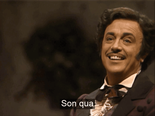 A Man In A Suit Is Singing With The Words Son Qua Written On The Bottom GIF