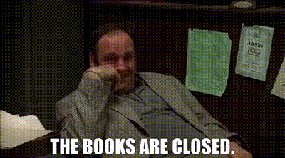 A Man In A Suit Is Sitting At A Desk With His Hand On His Chin And The Words The Books Are Closed . GIF