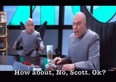 A Man In A Suit Is Sitting At A Table And Talking To A Smaller Man In A Suit . GIF