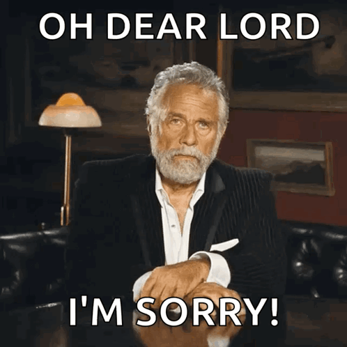 A Man In A Suit Is Sitting At A Table With The Words Oh Dear Lord I 'M Sorry Above Him GIF