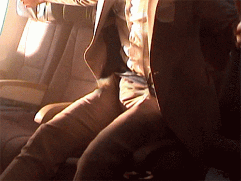 A Man In A Suit Is Sitting In A Car GIF