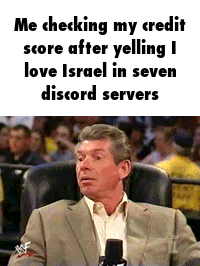 A Man In A Suit Is Sitting In A Chair With A Microphone In Front Of A Crowd . GIF