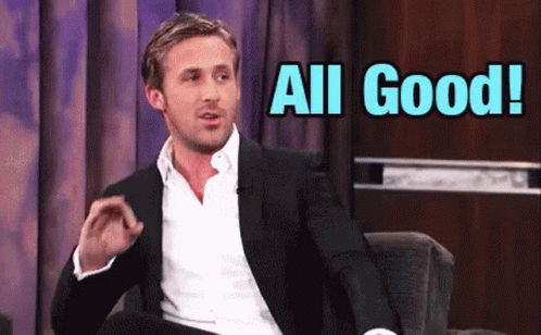 A Man In A Suit Is Sitting In A Chair With The Words All Good Behind Him GIF