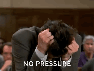 A Man In A Suit Is Sitting In A Courtroom Holding His Head . GIF