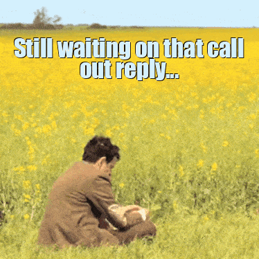A Man In A Suit Is Sitting In A Field Of Yellow Flowers With A Caption That Says Still Waiting On That Call Out Reply GIF