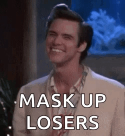 A Man In A Suit Is Smiling And Saying `` Mask Up Losers '' In Front Of An Aquarium . GIF