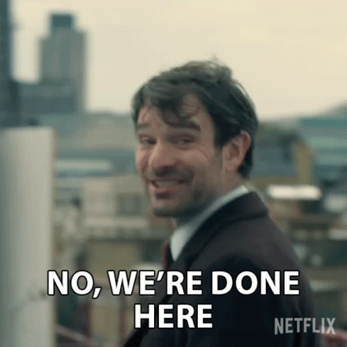 a man in a suit is smiling and says no , we 're done here .