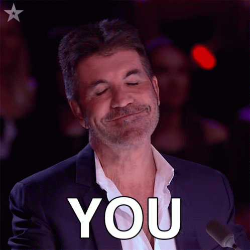 A Man In A Suit Is Smiling And Says You GIF