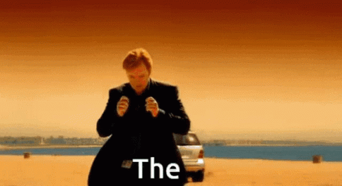 A Man In A Suit Is Standing In Front Of A Car With The Word The Written On The Screen GIF