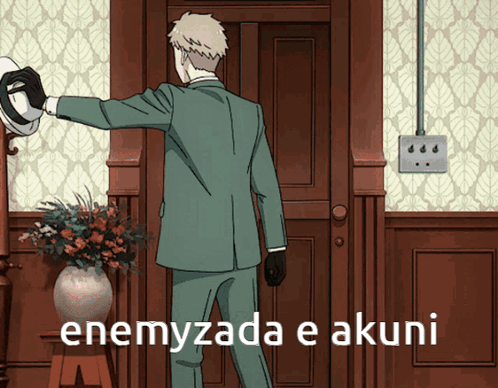 A Man In A Suit Is Standing In Front Of A Door With The Words Enemyzada E Akuni On The Bottom GIF