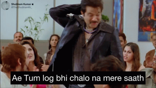 A Man In A Suit Is Standing In Front Of A Group Of People With The Caption Ae Tum Log GIF