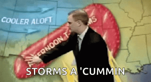 A Man In A Suit Is Standing In Front Of A Map That Says Storms A ' Cummin ' GIF