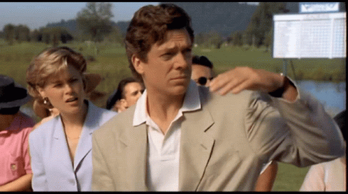 A Man In A Suit Is Standing In Front Of A Scoreboard That Says ' Masters ' GIF