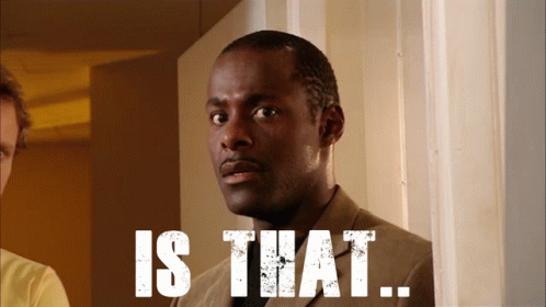 A Man In A Suit Is Standing In Front Of A Sign That Says " Is That " GIF
