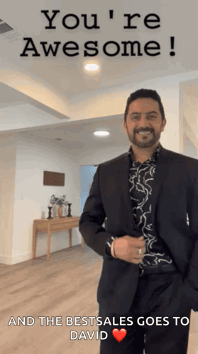 A Man In A Suit Is Standing In Front Of A Sign That Says " You 'Re Awesome " GIF