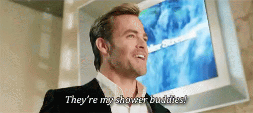A Man In A Suit Is Standing In Front Of A Television And Says They 'Re My Shower Buddies ! GIF