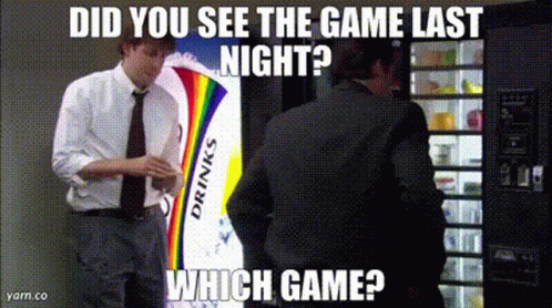 A Man In A Suit Is Standing In Front Of A Vending Machine That Says Drinks On It GIF