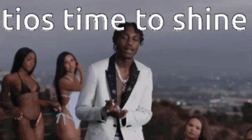 A Man In A Suit Is Standing In Front Of Three Bikinis . GIF