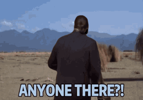 A Man In A Suit Is Standing In The Desert And Says Anyone There GIF