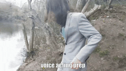 A Man In A Suit Is Standing Next To A Body Of Water And The Words Voice Acting Prep Are Above Him GIF