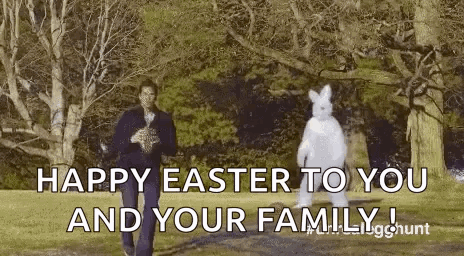 A Man In A Suit Is Standing Next To A Bunny In A Costume . GIF