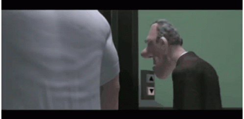 A Man In A Suit Is Standing Next To A Man In A White Shirt In An Elevator . GIF
