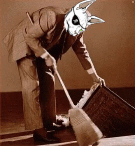 A Man In A Suit Is Sweeping The Floor With A Rabbit Mask On His Head GIF