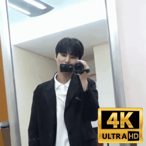A Man In A Suit Is Taking A Picture Of Himself In A 4K Ultra Hd Photo GIF