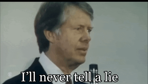 A Man In A Suit Is Talking Into A Microphone And Saying `` I 'Ll Never Tell A Lie '' . GIF
