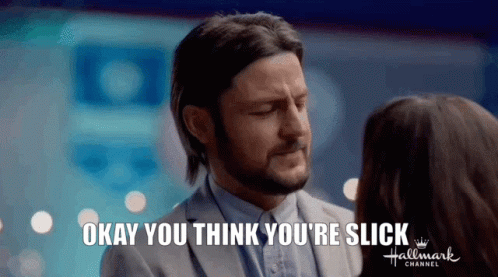 A Man In A Suit Is Talking To A Woman In A Hallmark Channel Ad . GIF