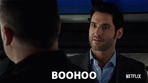 A Man In A Suit Is Talking To Another Man And The Word Boohoo Is Above Him GIF