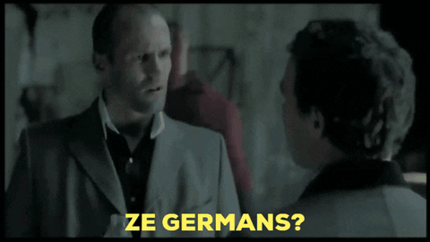 A Man In A Suit Is Talking To Another Man And The Words Ze Germans Are Visible GIF