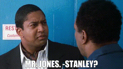 A Man In A Suit Is Talking To Another Man In A Blue Shirt And Says Mr. Jones Stanley . GIF