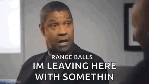 A Man In A Suit Is Talking To Another Man In A Room . GIF