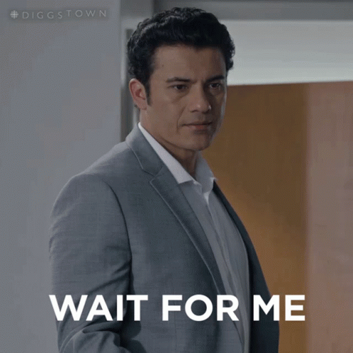 A Man In A Suit Is Waiting For Someone To Wait For Him GIF