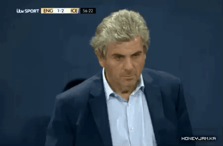 A Man In A Suit Is Watching A Soccer Game Between Ice And Eng GIF