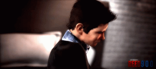 A Man In A Suit Looks Down With The Words Reed900 Behind Him GIF