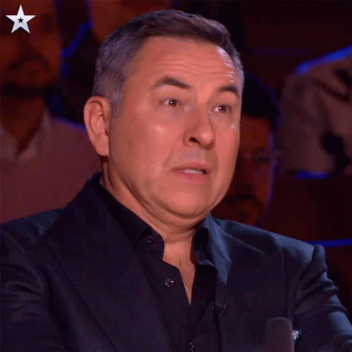 A Man In A Suit Making A Funny Face With A Star In The Corner GIF
