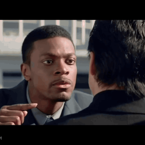 A Man In A Suit Points At Another Man In A Black Suit GIF
