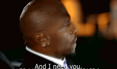 A Man In A Suit Says " And I Need You " In A Dark Room GIF
