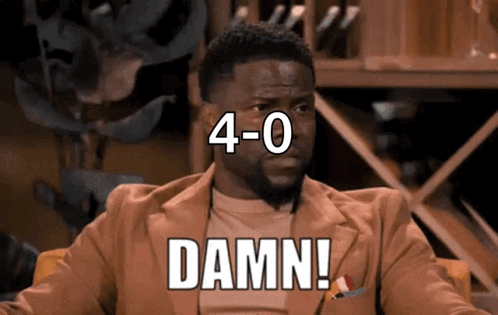 A Man In A Suit Says Damn In Front Of A Wine Shelf GIF